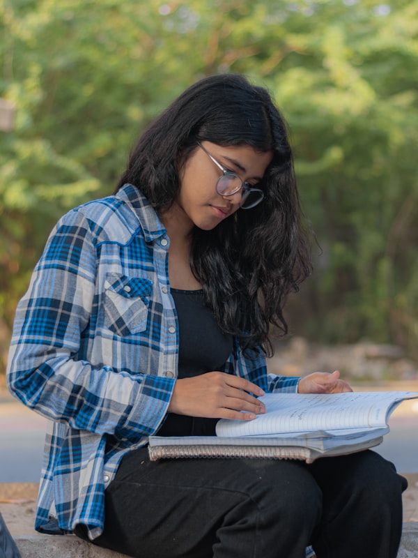 A learner taking notes while studying